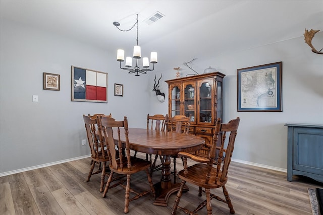 1036 Ridgetop Dr, Justin, TX 76247 - dining room with a chandelier, light wood-style floors, and baseboards