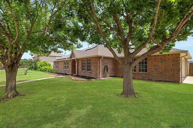 1036 Ridgetop Dr, Justin, TX 76247 - ranch-style home featuring brick siding, roof mounted solar panels, a front lawn, and a shingled roof