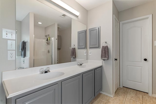 1036 Ridgetop Dr, Justin, TX 76247 - bathroom featuring double vanity, a shower stall, and baseboards