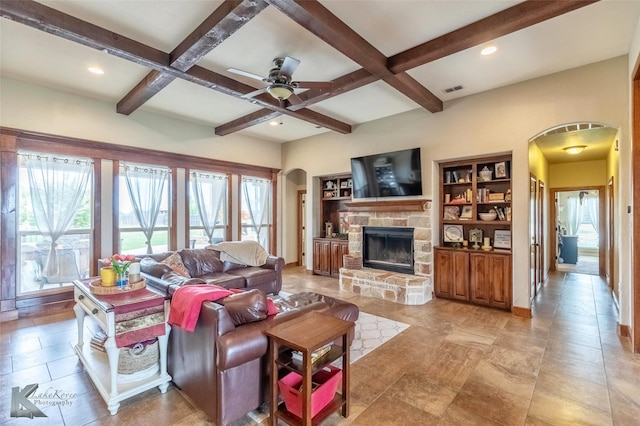 602 Prosperity Rd, Abilene, TX 79602 - living room featuring arched walkways, beamed ceiling, coffered ceiling, a fireplace, and a ceiling fan