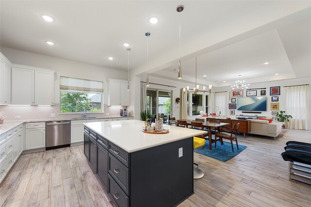 11017 Cartwright Dr, Denton, TX 76207 - kitchen featuring dishwasher, a sink, open floor plan, a chandelier, and light countertops