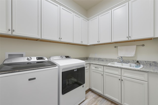 11017 Cartwright Dr, Denton, TX 76207 - laundry room featuring washer and dryer, cabinet space, and light wood-style flooring