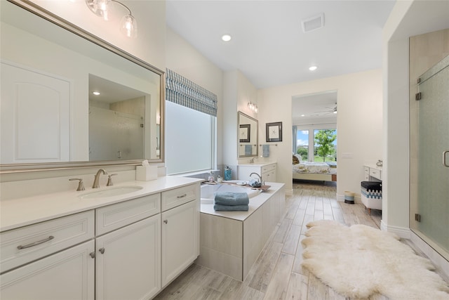 11017 Cartwright Dr, Denton, TX 76207 - ensuite bathroom with a shower stall, vanity, wood finished floors, ceiling fan, and recessed lighting