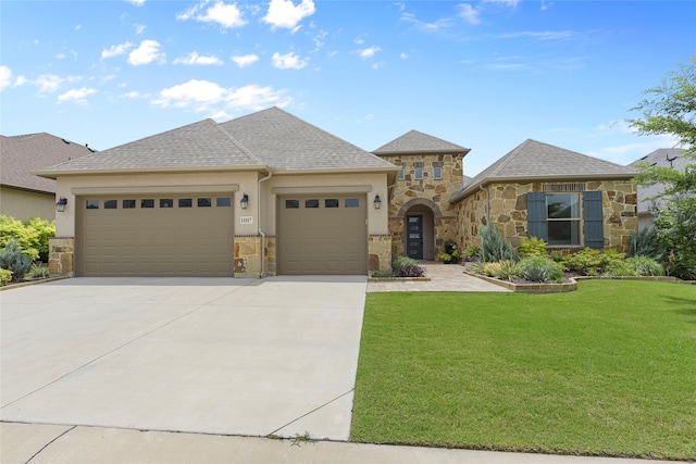 11017 Cartwright Dr, Denton, TX 76207 - french country style house with a garage, concrete driveway, stone siding, and a front lawn