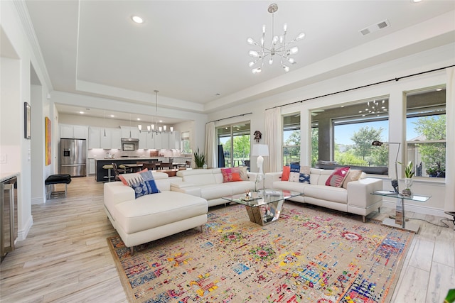 11017 Cartwright Dr, Denton, TX 76207 - living room featuring a chandelier, a raised ceiling, light wood-style floors, recessed lighting, and baseboards