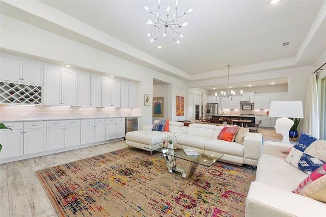 11017 Cartwright Dr, Denton, TX 76207 - living area with a chandelier, light wood-style flooring, a tray ceiling, and recessed lighting