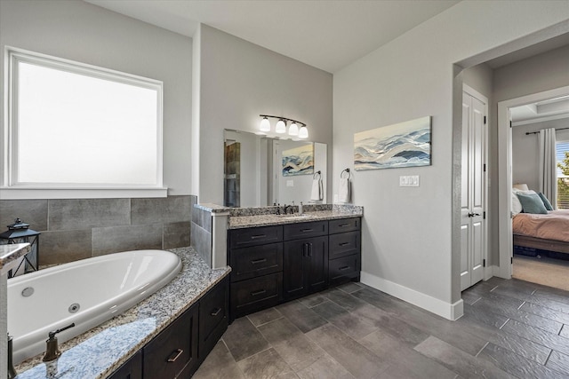 1007 Sinopa St, Caddo Mills, TX 75135 - bathroom with vanity, a whirlpool tub, ensuite bath, and baseboards