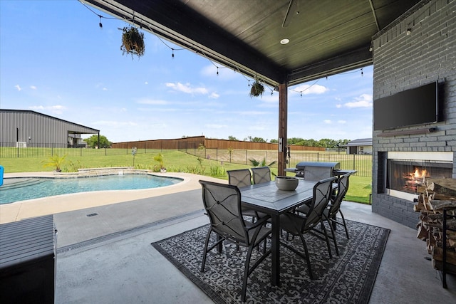 1007 Sinopa St, Caddo Mills, TX 75135 - view of patio with an outdoor brick fireplace and outdoor dining area