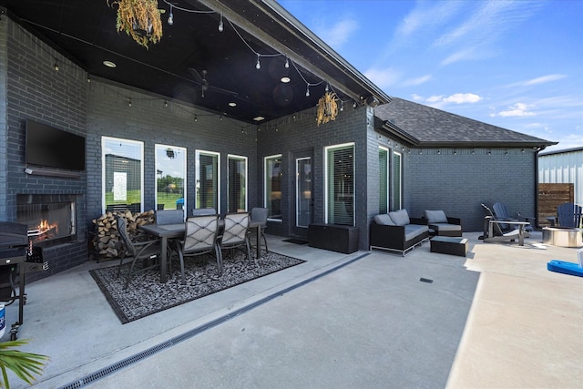 1007 Sinopa St, Caddo Mills, TX 75135 - view of patio / terrace with a fireplace, ceiling fan, and outdoor dining space