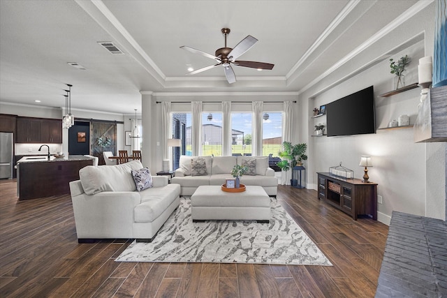 1007 Sinopa St, Caddo Mills, TX 75135 - living room with a tray ceiling, ceiling fan, crown molding, and dark wood-style floors