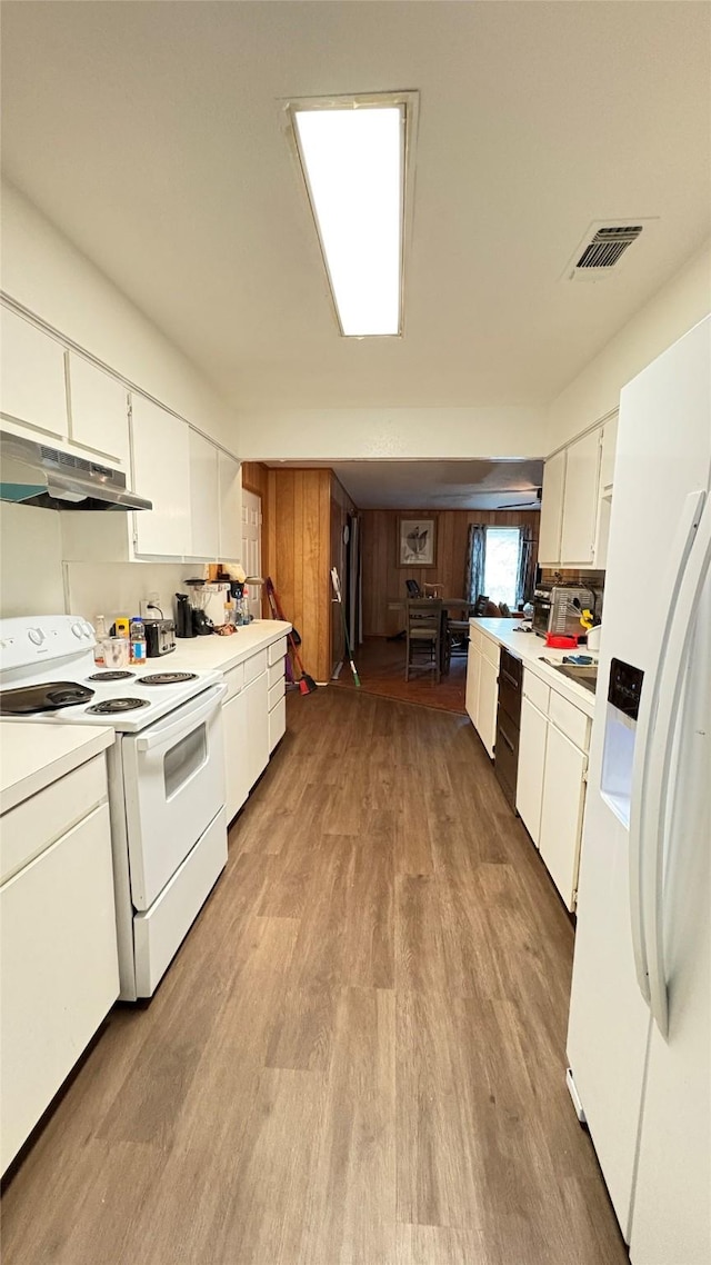 5632 Taylor Rd, River Oaks, TX 76114 - kitchen with white appliances, under cabinet range hood, light wood-style floors, light countertops, and white cabinetry