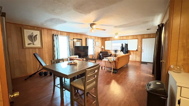 5632 Taylor Rd, River Oaks, TX 76114 - dining room with wooden walls, dark wood-style floors, ceiling fan, and baseboards