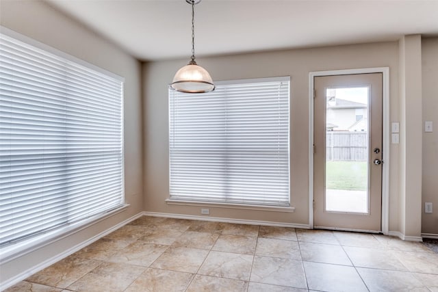 2600 Spencer Cir, Royse City, TX 75189 - unfurnished dining area with plenty of natural light, light tile patterned floors, and baseboards