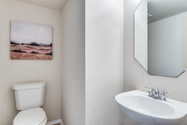 2600 Spencer Cir, Royse City, TX 75189 - half bath with a sink, toilet, and baseboards