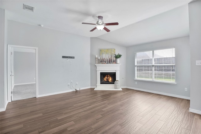 2814 Saddlebred Trl, Celina, TX 75009 - unfurnished living room with vaulted ceiling, a ceiling fan, dark wood-style flooring, a lit fireplace, and baseboards