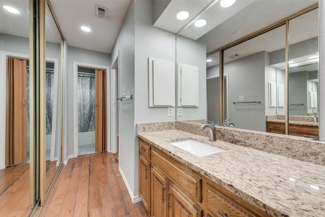 2537 Montclair Ln, Mesquite, TX 75150 - bathroom with vanity, wood finished floors, baseboards, and recessed lighting