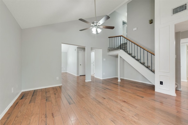 2537 Montclair Ln, Mesquite, TX 75150 - unfurnished living room featuring ceiling fan, light wood-style flooring, stairs, high vaulted ceiling, and baseboards