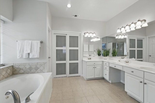 14620 Windsor Ct, Addison, TX 75001 - bathroom with tile patterned floors, double vanity, a tub with jets, and a stall shower
