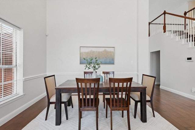 14620 Windsor Ct, Addison, TX 75001 - dining room with wood finished floors, baseboards, stairs, and a high ceiling
