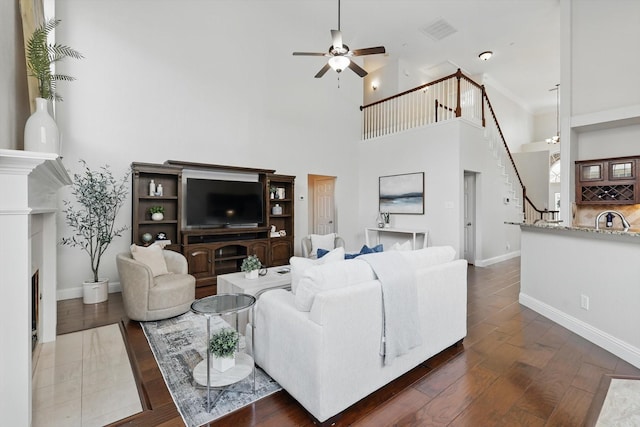 14620 Windsor Ct, Addison, TX 75001 - living area featuring a ceiling fan, stairway, baseboards, and a towering ceiling