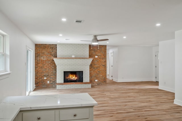 436 Crestwood Ter, Hurst, TX 76053 - unfurnished living room with a ceiling fan, light wood-type flooring, a brick fireplace, recessed lighting, and baseboards