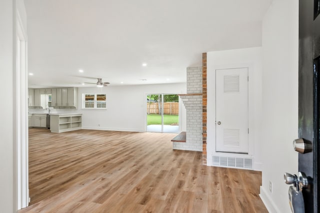 436 Crestwood Ter, Hurst, TX 76053 - unfurnished living room featuring a fireplace, baseboards, light wood-style floors, a ceiling fan, and recessed lighting