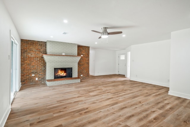 436 Crestwood Ter, Hurst, TX 76053 - unfurnished living room featuring light wood-type flooring, a brick fireplace, ceiling fan, baseboards, and recessed lighting
