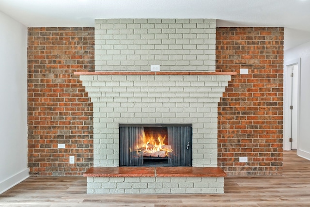 436 Crestwood Ter, Hurst, TX 76053 - detailed view of a brick fireplace, wood finished floors, and baseboards