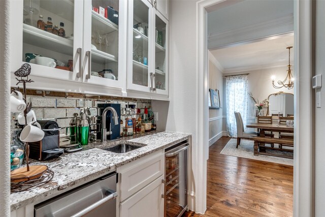 6242 Vickery Blvd, Dallas, TX 75214 - indoor wet bar with beverage cooler, crown molding, stainless steel dishwasher, decorative backsplash, and wood finished floors