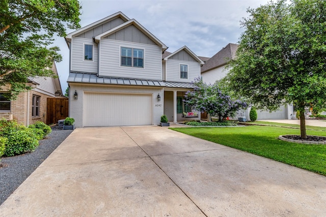 6242 Vickery Blvd, Dallas, TX 75214 - view of front of home with board and batten siding, brick siding, driveway, and a garage