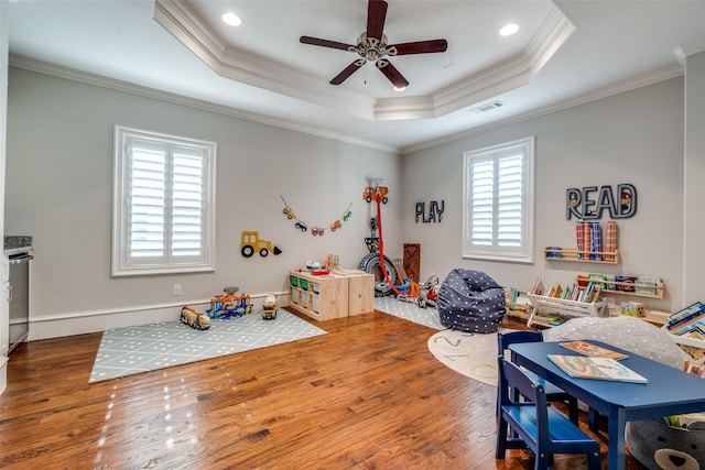 6242 Vickery Blvd, Dallas, TX 75214 - recreation room featuring wood finished floors, ceiling fan, a tray ceiling, ornamental molding, and recessed lighting