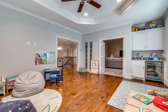 6242 Vickery Blvd, Dallas, TX 75214 - game room with wine cooler, wood finished floors, bar area, a raised ceiling, and ornamental molding