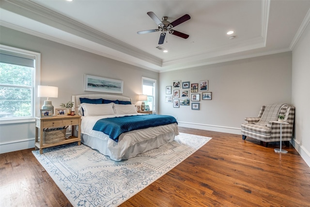 6242 Vickery Blvd, Dallas, TX 75214 - bedroom featuring multiple windows, a tray ceiling, wood finished floors, crown molding, and baseboards