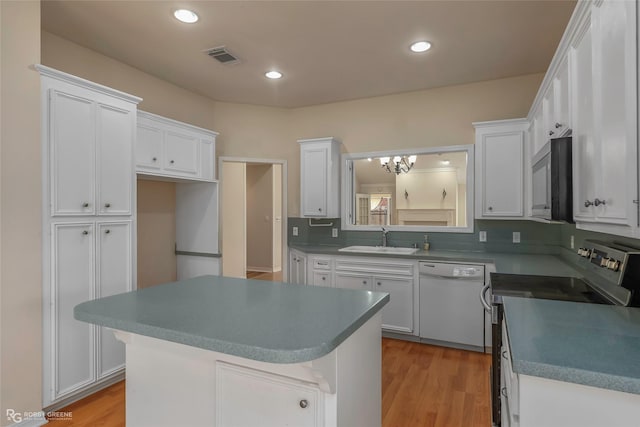 10085 Baldwin Ct, Shreveport, LA 71115 - kitchen with dishwasher, stainless steel electric range oven, a sink, white cabinetry, and recessed lighting