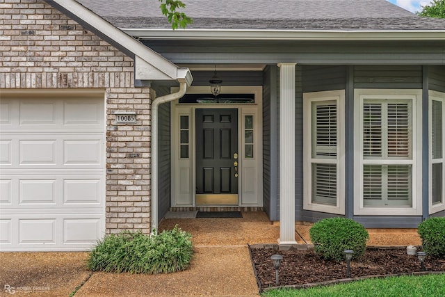 10085 Baldwin Ct, Shreveport, LA 71115 - doorway to property featuring a shingled roof, an attached garage, and stone siding