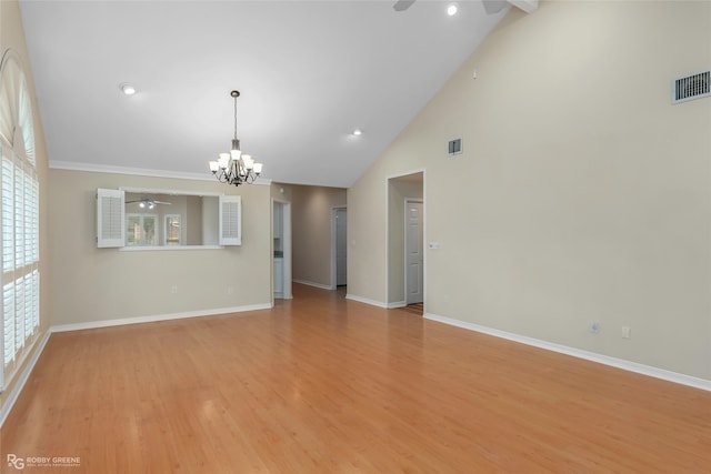 10085 Baldwin Ct, Shreveport, LA 71115 - spare room with ceiling fan, a chandelier, high vaulted ceiling, light wood-style floors, and baseboards
