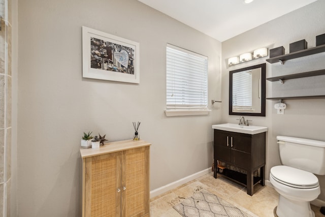 9834 Carnegie Dr, Dallas, TX 75228 - bathroom with vanity, toilet, baseboards, and tile patterned floors