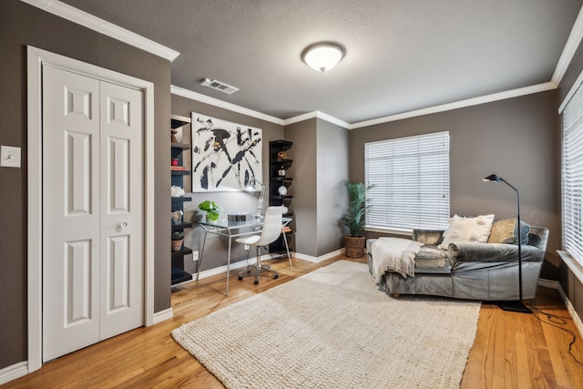9834 Carnegie Dr, Dallas, TX 75228 - office featuring crown molding, wood finished floors, healthy amount of natural light, baseboards, and a textured ceiling