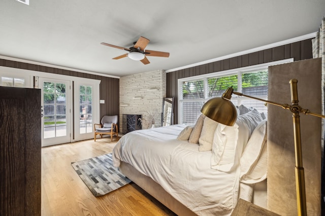 9834 Carnegie Dr, Dallas, TX 75228 - bedroom with access to outside, wood finished floors, crown molding, wooden walls, and ceiling fan