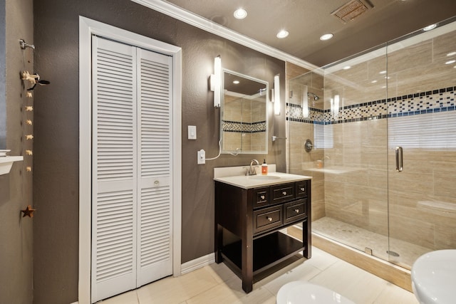 9834 Carnegie Dr, Dallas, TX 75228 - bathroom with a closet, vanity, a shower stall, tile patterned floors, and ornamental molding