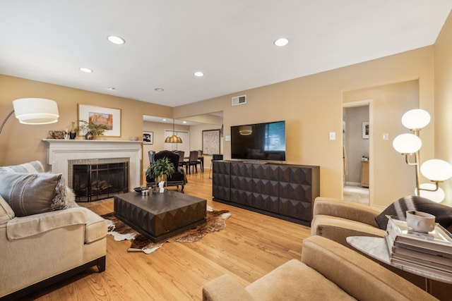 9834 Carnegie Dr, Dallas, TX 75228 - living room featuring wood finished floors, recessed lighting, and a fireplace
