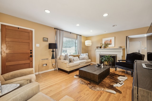 9834 Carnegie Dr, Dallas, TX 75228 - living area featuring baseboards, light wood-style flooring, a lit fireplace, and recessed lighting