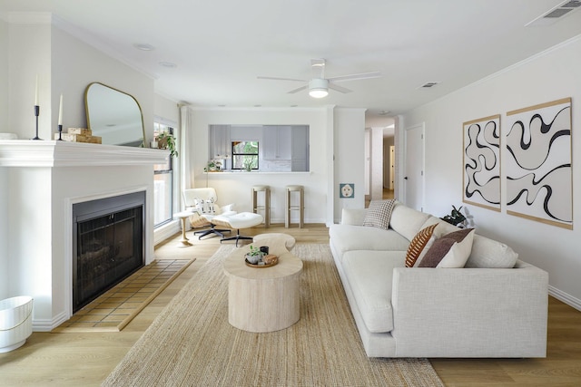 4040 Morman Ln, Addison, TX 75001 - living area with wood finished floors, a ceiling fan, a fireplace, ornamental molding, and baseboards