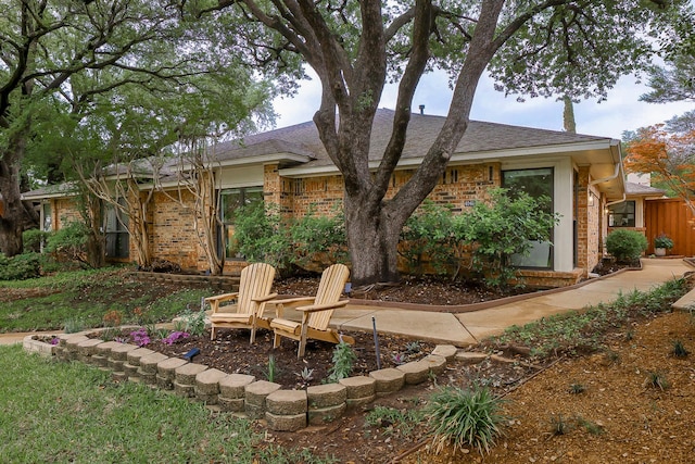 4040 Morman Ln, Addison, TX 75001 - rear view of house featuring brick siding and a shingled roof