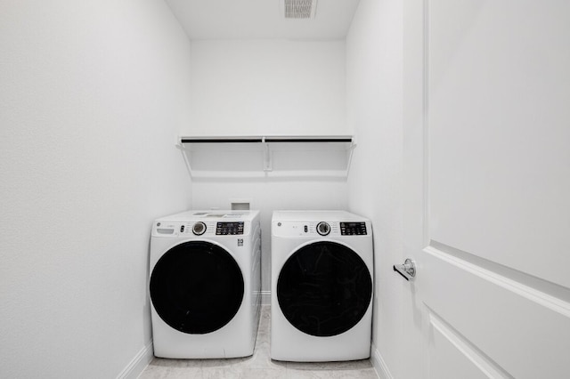 1204 Toro Trl, Fort Worth, TX 76052 - laundry area featuring washer and clothes dryer, baseboards, and light tile patterned floors