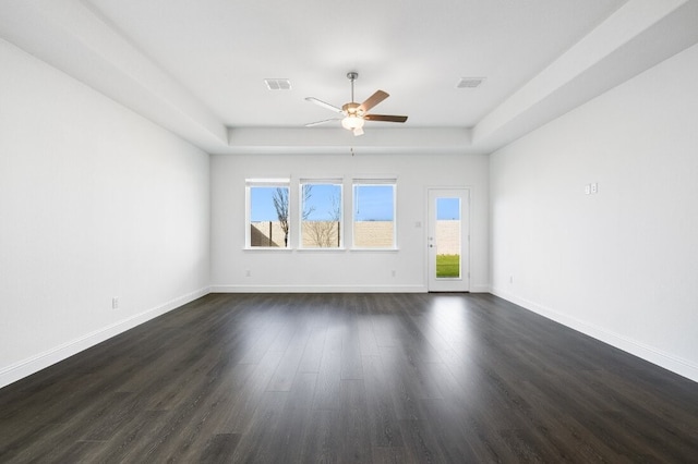 1204 Toro Trl, Fort Worth, TX 76052 - unfurnished room featuring ceiling fan, dark wood-type flooring, baseboards, and a raised ceiling