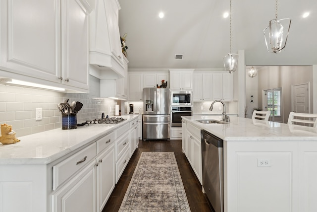 8900 Hidden Pond St, Justin, TX 76247 - kitchen with stainless steel appliances, a sink, lofted ceiling, tasteful backsplash, and white cabinets
