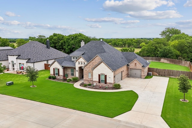 8900 Hidden Pond St, Justin, TX 76247 - french country style house featuring concrete driveway, an attached garage, a chimney, brick siding, and stone siding