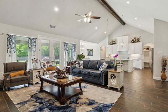 8900 Hidden Pond St, Justin, TX 76247 - living area with arched walkways, beamed ceiling, a ceiling fan, high vaulted ceiling, and dark wood-style floors
