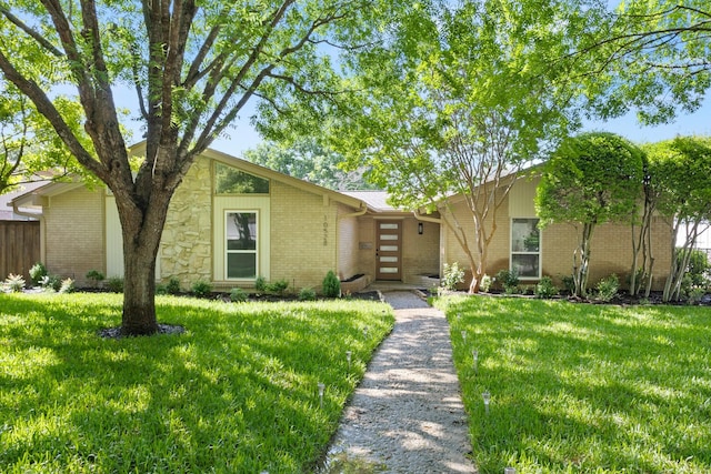 10528 Swallow Ln, Dallas, TX 75218 - mid-century home with brick siding, a front yard, and stone siding